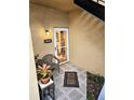 Inviting front porch with outdoor seating, decorative lighting, and a secure, glass-paneled front door at 3810 N Oak Dr # N31, Tampa, FL 33611