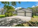 Spacious three-car garage with ample parking on a wide driveway at 389 Grand Bay Dr, Palm Harbor, FL 34683