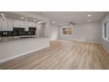 Open-concept living room with modern flooring and abundant natural light, seamlessly connected to the kitchen at 4441 16Th N St, St Petersburg, FL 33703