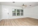 Bright living room with wood-look flooring, white walls, and abundant natural light at 4611 W 18Th Ave, Bradenton, FL 34209