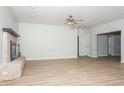Living room with brick fireplace, wood-look flooring, and an open floor plan at 4611 W 18Th Ave, Bradenton, FL 34209
