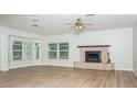 Spacious living room features a brick fireplace, wood-look flooring and neutral paint at 4611 W 18Th Ave, Bradenton, FL 34209
