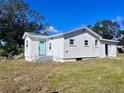 Charming single-story home with a white stucco exterior and a bright blue front door at 4701 17Th S Ave, St Petersburg, FL 33711