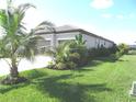 Beautiful single-story home featuring a well-maintained lawn, tropical landscaping, and a two-car garage with a paver driveway at 4957 Seafoam Trl, Bradenton, FL 34211