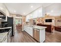 Bright kitchen featuring modern stainless steel appliances, granite counters, and white cabinetry at 6709 Peachtree Dr, Temple Terrace, FL 33617