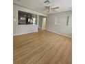 Open concept living room with wood floors and view into modern kitchen at 7001 60Th N St, Pinellas Park, FL 33781