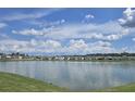 Scenic lake view showcasing the tranquil waterfront lifestyle and beautiful homes in the community at 7575 Sail Clover Ln, Zephyrhills, FL 33540