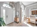Bright foyer with high ceilings, tiled floor, and decorative chandelier, offering a warm welcome at 9202 Brindlewood Dr, Odessa, FL 33556