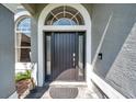 Inviting front door with sidelights and transom window, creating a grand entrance at 9202 Brindlewood Dr, Odessa, FL 33556
