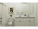 Bathroom featuring double vanity with marble countertops, modern fixtures, and tiled shower at 9497 Minnow Ray Dr, Land O Lakes, FL 34638