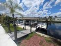 Waterfront property featuring a private dock, with direct water access and space for leisure and recreation by the water at 1008 Sago Palm Way, Apollo Beach, FL 33572