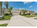 Beautiful one-story home with landscaped front yard, a two-car garage and a red front door at 10409 Glen Willow Ln, Tampa, FL 33647