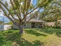 Charming single-story home with mature tree in front yard and covered front porch, exuding curb appeal and character at 1136 Granada St, Clearwater, FL 33755