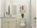 Bright bathroom with white vanity, marble countertop, and classic subway tile shower at 11828 Sparkling Topaz Cv, Parrish, FL 34219