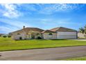 Charming single-story home with a well-manicured lawn and large airplane hangar at 11908 Pilot Country Dr, Spring Hill, FL 34610