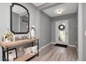Inviting foyer with light gray walls, wood-look floors, and stylish console table with elegant decor at 12138 Criollo Rd, Spring Hill, FL 34610