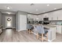 Bright kitchen with white cabinets, stainless steel appliances, and an island with barstool seating at 12138 Criollo Rd, Spring Hill, FL 34610