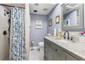 Stylishly renovated bathroom with a granite vanity, modern fixtures, and tiled shower at 12234 Cider Mill Ln, Hudson, FL 34667