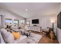 Comfortable living room with ample seating, stylish decor, large windows, and hardwood flooring at 13028 Wellspring Dr, Lithia, FL 33547