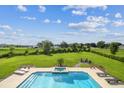 The expansive backyard features a pool, spa, and seating areas with lush landscaping at 17914 Howsmoor Pl, Lutz, FL 33559