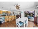 Inviting dining area adjacent to kitchen, featuring a unique starburst chandelier and sliding glass doors at 1983 Seton Dr, Clearwater, FL 33763
