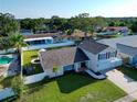 Aerial view of a lovely two-story home with a spacious backyard and a well-maintained lawn at 2897 Rosery Ne Rd, Largo, FL 33771