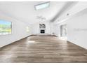 Bright, expansive living room with wood floors, fireplace, and skylights at 290 13Th N Ave, Safety Harbor, FL 34695