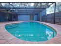 Inviting backyard pool with a spacious covered patio and brick surround at 290 13Th N Ave, Safety Harbor, FL 34695