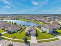 Stunning aerial view of a home with pond and meticulously maintained lawns at 30732 Summer Sun Loop, Wesley Chapel, FL 33545
