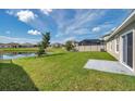 Lush backyard featuring a pond view and private screened-in pool at 30732 Summer Sun Loop, Wesley Chapel, FL 33545