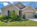 Inviting home featuring a well-maintained lawn and attached two-car garage at 30732 Summer Sun Loop, Wesley Chapel, FL 33545