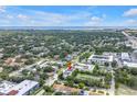 Aerial view of the townhome nestled in a neighborhood with a nearby ocean in the distance at 3807 W Cleveland St, Tampa, FL 33609