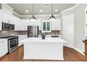 Bright, modern kitchen with a white island, stainless steel appliances, and wood floors at 3807 W Cleveland St, Tampa, FL 33609