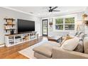 Comfortable living room with hardwood floors, large TV, and plenty of natural light at 403 E North St, Tampa, FL 33604