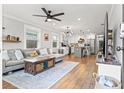Bright, open floor plan with hardwood floors, grey sofa, and kitchen with island at 403 E North St, Tampa, FL 33604