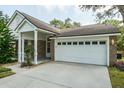 Attached two-car garage with white door and well-kept brick exterior at 4167 Seton Cir, Palm Harbor, FL 34683
