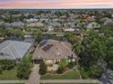 Aerial view of a home with solar panels, a screened lanai, and lush landscaping in a quiet residential neighborhood at 4615 Shark Dr, Bradenton, FL 34208