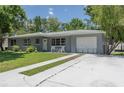 A charming single-story home with a freshly sealed driveway and well-manicured lawn at 4917 99Th N St, St Petersburg, FL 33708