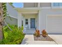 Cozy front porch with seating and a well-maintained garden, creating a welcoming entrance at 5438 Summer Sunset Dr, Apollo Beach, FL 33572