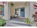 A cozy front porch features a welcome wreath, bench, and plants at 5918 Beaconpark St, Lithia, FL 33547