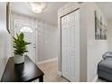 Inviting entryway features wood-look flooring, a coat closet, and modern lighting at 602 Timber Bay W Cir, Oldsmar, FL 34677
