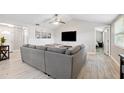 Spacious living room with vaulted ceiling, neutral tones and views to adjacent rooms at 602 Timber Bay W Cir, Oldsmar, FL 34677