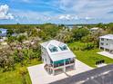 Stunning aerial view of a coastal home showcasing its premium location near the water and lush greenery at 6679 Wander Ln, New Port Richey, FL 34652