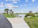 Community boat ramp access with paved walkway, perfect for enjoying waterfront activities and scenic views at 6715 Wander Ln, New Port Richey, FL 34654