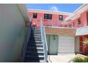Exterior view of building with stairwell leading up to units at 6800 Sunset Way # 1708, St Pete Beach, FL 33706
