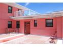 Exterior view of a charming residence with a cozy patio area and outdoor seating at 6800 Sunset Way # 1708, St Pete Beach, FL 33706