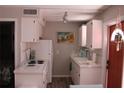 Functional kitchen featuring white cabinetry and essential appliances at 6800 Sunset Way # 1708, St Pete Beach, FL 33706
