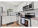 Well-equipped kitchen with stainless steel appliances, granite counters, and white subway tile backsplash at 6806 N 17Th St, Tampa, FL 33610