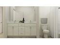 Bright bathroom with double vanity, white cabinets, and modern fixtures at 6830 E 115Th St, Palmetto, FL 34221