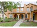 Exterior view of a two-story townhome with manicured front lawn and welcoming entrance at 6925 Marble Fawn Pl, Riverview, FL 33578